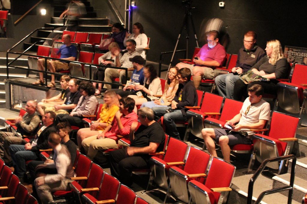 The audience, prior to the beginning of the movie.